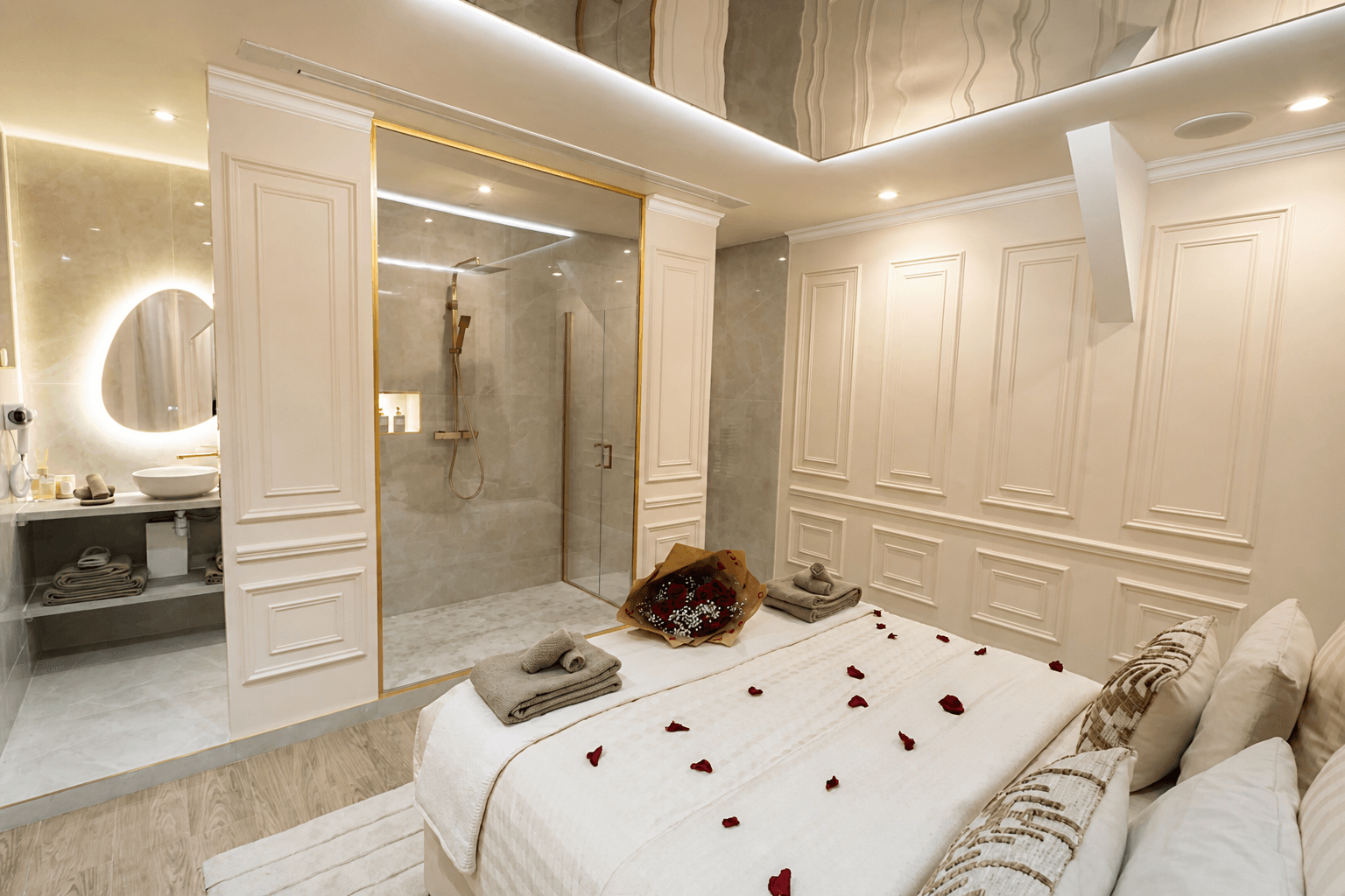 The bedroom and its glass wall opening onto the bathroom